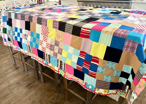 69" wide x 87" long vintage polyester double knit pieced quilt with poly-cotton sheet backing, tied with yarn, good condition; fun colors!!