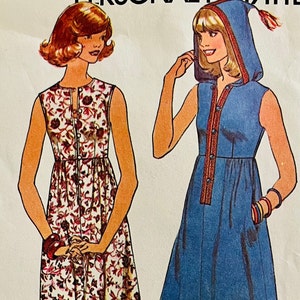 May include: Two sleeveless dresses, one with a floral print and the other a solid blue with a hood. Both dresses have a button-up front.