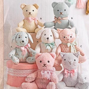May include: A collection of plush stuffed animals including bears, rabbits, and cats in various pastel colors and floral patterns. Each animal features a ribbon tied around its neck and is labeled with letters A, B, or C to indicate different designs.