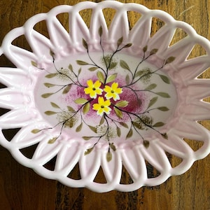 Vintage hand-painted pink dish with pierced edging, yellow and green florals on darker pink background, excellent condition, no markings.