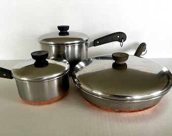 Vintage Revere Ware 1801 copper-bottom stainless steel saucepans and frying pan with lids, selling separately.