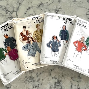 May include: Four vintage Kwik Sew sewing pattern packets. The packets feature illustrations of jackets and sweatshirts. The packets are white with black text and illustrations. The patterns are for sizes 4-20 and include pattern numbers 2133, 1494, 2291, and 2269.
