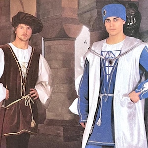May include: Two men in medieval-style costumes. One wears a brown velvet tunic over a white shirt, with a matching hat. The other wears a blue tunic with a white and silver overcoat and a blue hat.