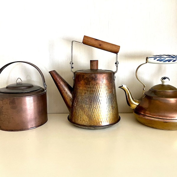 Vintage copper or lined copper tea pots with brass details, each different, all in wonderful condition with lid and finial, sold separately.