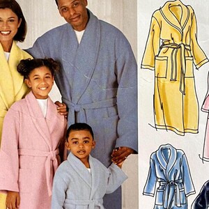 May include: A family of four wearing different colored robes. The robes are all long-sleeved and have a shawl collar. The robes are in yellow, pink, blue, and light blue.