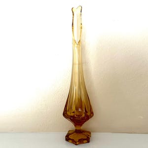 Vintage amber glass swung vase with hexagonal base, excellent condition; 13.5&quot; tall x 3.25&quot; wide at widest part, base is 2 3/8&quot; wide.