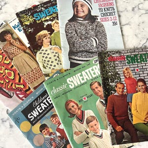 May include: A collection of vintage knitting and crochet pattern books. The covers feature images of sweaters, children, and adults. The books are in various colors, including green, blue, and red. Some books have text that reads "Children's Fashions to Knit & Crochet Sizes 2-12".