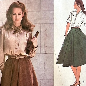 May include: A vintage sewing pattern featuring a woman wearing a long-sleeved blouse with a bow tie and a brown skirt. The pattern includes a separate illustration of a green skirt.