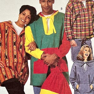 May include: A sewing pattern featuring three different hooded tops. The first top is a red, orange, and black striped hooded top. The second top is a green, yellow, and red hooded top. The third top is a blue hooded top. The pattern includes the text "SIZE TAILLE 2 (LRG,ARG) FABRICLAND."