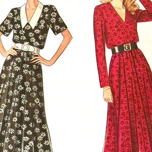 May include: Two long dresses with a V-neckline and a belt. The dress on the left is black with white floral print and short sleeves. The dress on the right is red with a floral print and long sleeves.