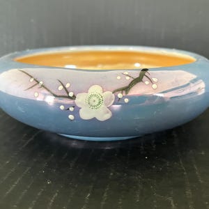 Vintage lusterware bowl made in Japan, blue exterior with painted florals and moriage dots, orange luster interior; 7.25&quot; in diameter x 2&quot;.