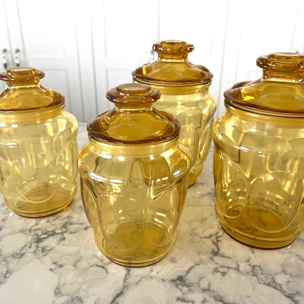 Vintage amber-colored canister jars with rubber gaskets on lid, oval medallions around body and around lid, all in terrific condition.