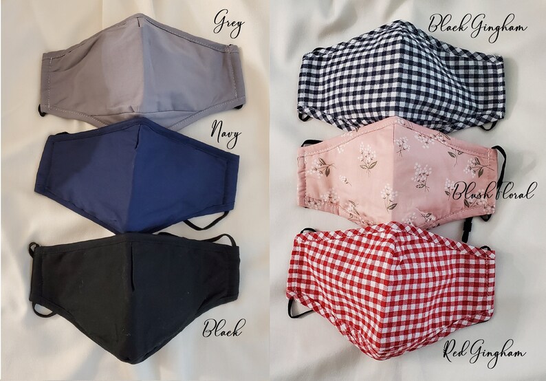 May include: Selection of face masks in different colours and patterns. Includes solid grey, navy, and black masks, plus gingham and floral designs. Each mask has adjustable ear loops for a comfortable fit.