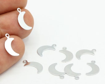 May include: A set of nine silver crescent moon charms with jump rings. The charms are about 1 inch in size.