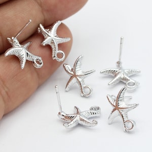 May include: Six silver starfish earring charms with jump rings. The charms are designed with a detailed starfish shape and are ready to be added to earrings.