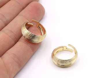 May include: Two gold-toned adjustable rings with a ridged, textured surface.