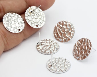 May include: Five silver-toned round earring blanks with a textured surface. Each blank has a post for attaching to an earring.
