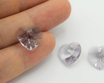 May include: Three clear crystal heart-shaped charms with a faceted design. The charms have a small hole at the top for hanging.
