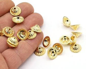 May include: A group of gold-colored metal bead caps with a decorative, textured design. The caps have a small hole in the center for stringing.