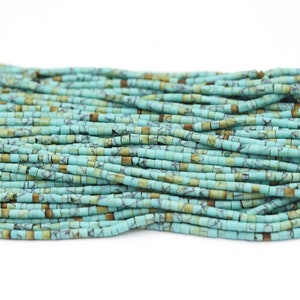 May include: A strand of turquoise blue and brown square beads. The beads are small and have a mottled pattern.