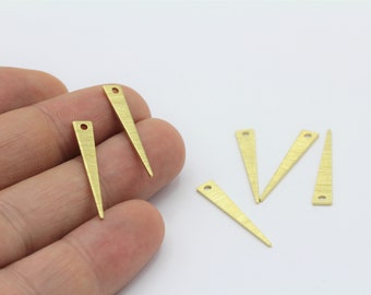 May include: Five gold-colored metal triangle shapes with a hole at the top. The triangles are pointed at the bottom and have a textured surface.