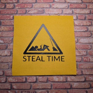 May include: Yellow warning sign with a black triangle and a stick figure lying down. The text "STEAL TIME" is printed below the triangle.