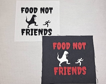 May include: Two black and white patches with the text "Food Not Friends" and a silhouette of a dinosaur and a running person. The patches are on a white and black checkered background.