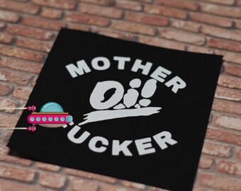 May include: Black fabric patch with white text that reads "Mother Oi!  Fucker".