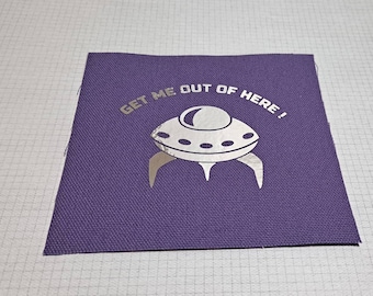 May include: A purple fabric patch with a silver metallic design of a UFO and the text "GET ME OUT OF HERE!"
