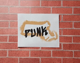 May include: A white canvas patch with a brown outline of the state of Massachusetts and the word "PUNK" written in black inside the outline.