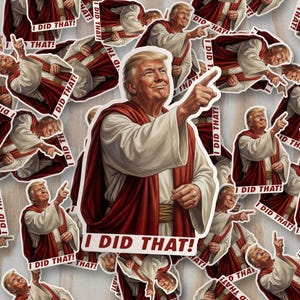 May include: A collection of stickers featuring a portrait of a man in a white robe with a red shawl, pointing. The text "I DID THAT!" is on each sticker. The stickers are scattered on a light wood-grain surface.