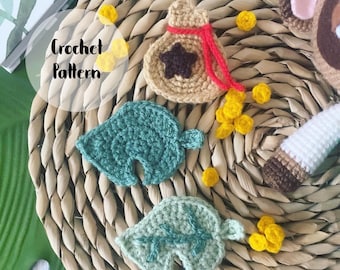 May include: Crochet pattern for a green leaf, a brown bag with a red string and a star, and a pile of yellow coins. The pattern is called "Crochet Pattern".