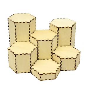 May include: A set of six hexagonal wooden display stands, arranged in a honeycomb pattern. The stands are made of light brown wood and have a natural finish.