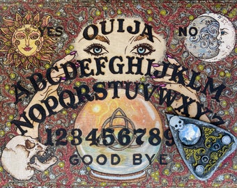 May include: A rectangular wooden Ouija board featuring a central crystal ball with a triquetra symbol, surrounded by the alphabet, numbers zero through nine, and the words YES, NO, and GOOD BYE. The board includes a sun, moon, and skull illustration.
