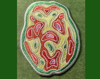 May include: Embroidered patch with an abstract design. The patch features a complex pattern of red, orange, yellow, and pink shapes outlined in white and green stitching. The patch is on a green background.