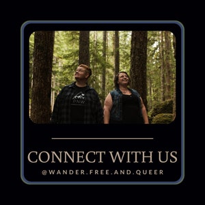 May include: Two people stand in a forest, looking up at the trees. The person on the left is wearing a plaid shirt with the letters "PNW" on the front. The person on the right is wearing a black shirt and a denim vest. The text "CONNECT WITH US @WANDER.FREE.AND.QUEER" is at the bottom of the image.