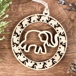 May include: A wooden ornament shaped like a circle with a large elephant cutout in the center. The elephant is surrounded by a ring of smaller elephant cutouts.