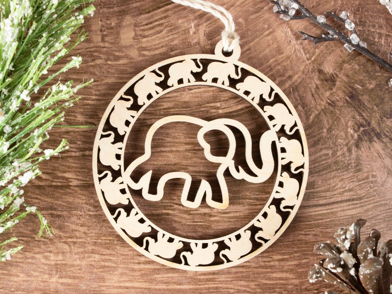 May include: A wooden ornament shaped like a circle with a large elephant cutout in the center. The elephant is surrounded by a ring of smaller elephant cutouts.