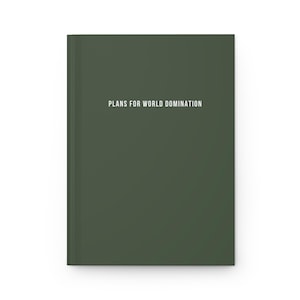 May include: A dark green notebook with the text "Plans for World Domination" printed in white on the front cover.