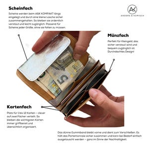 May include: Open wallet with multiple compartments, including a bill compartment with Euro currency, card slots, and a coin pocket. The wallet is made of a light brown material with a silver accent. Text on the image describes features.