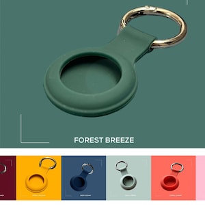 May include: A green silicone keychain with a round, hollow center and a silver metal ring. The keychain is labeled "FOREST BREEZE".