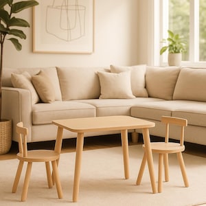 May include: A light-colored wooden children's table with rounded corners and four tapered legs, accompanied by two matching wooden chairs with low backrests and round seats, all featuring a smooth, natural finish and simple construction.