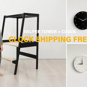 May include: A black wooden helper tower with a light wood platform and step, accompanied by four circular wall clocks in black, light wood, and white finishes with minimalist numerical designs and thin clock hands mounted on a plain wall.