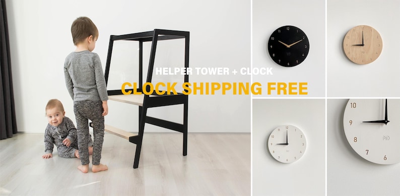 May include: A black wooden helper tower with a light wood platform and step, accompanied by four circular wall clocks in black, light wood, and white finishes with minimalist numerical designs and thin clock hands mounted on a plain wall.