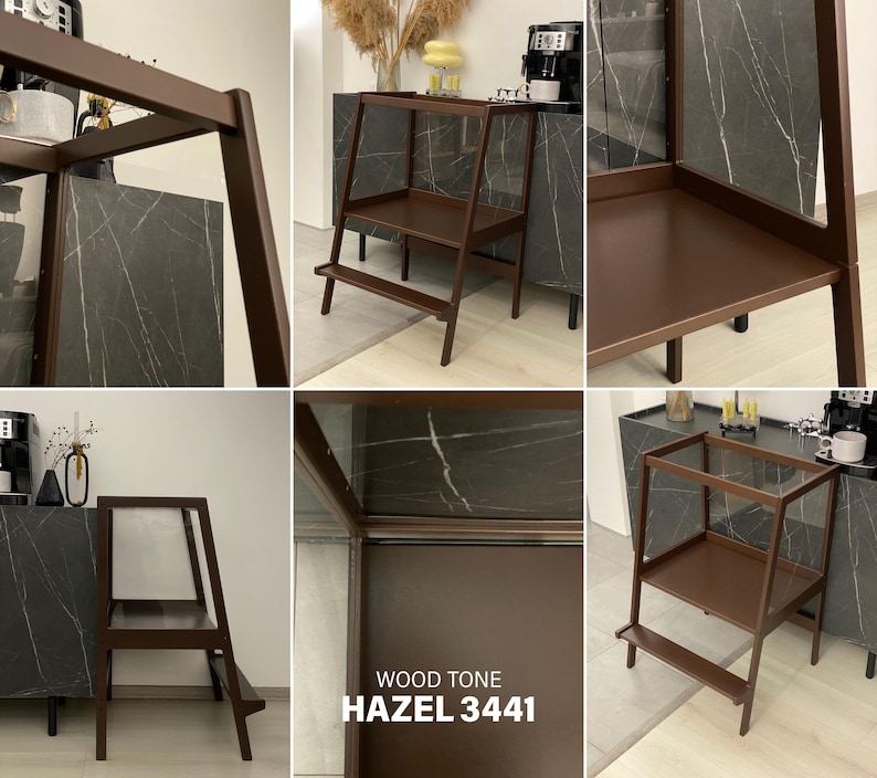 May include: A dark brown wooden step stool featuring a two-tier design with a wide top platform and a lower step. The frame is constructed with angled side supports. The text WOOD TONE HAZEL 3441 is printed on the surface of the stool structure.