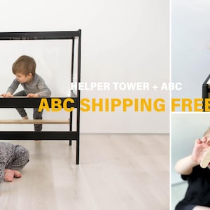 May include: A black wooden helper tower with a horizontal bar and a set of light-colored wooden alphabet letters. The letters are shaped like various characters and can be stacked or held. The text HELPER TOWER + ABC is visible in the image.
