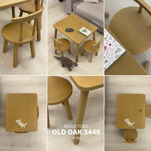 May include: A wooden children's furniture set in an old oak 3440 wood tone, featuring a rectangular table and two round chairs with backrests. The set includes a dinosaur-shaped decorative element and text reading WOOD TONE OLD OAK 3440 H 46.