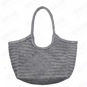 May include: A gray woven tote bag with a braided handle. The bag has a rounded shape and a textured surface. The text on the image says "Braided & Shipped directly from Artisans You get Best Quality at Economical Price."