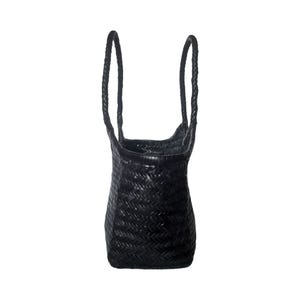 May include: Black woven tote bag with braided handles. The bag has a rectangular base and a slightly flared top. The weave pattern is tight and consistent, giving the bag a structured appearance. The handles are long enough to be worn over the shoulder.