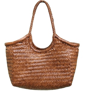 May include: A woven brown tote bag with a braided handle. The bag has a rectangular shape with rounded corners and a wide opening. The weave pattern is visible throughout the bag's body and handle.